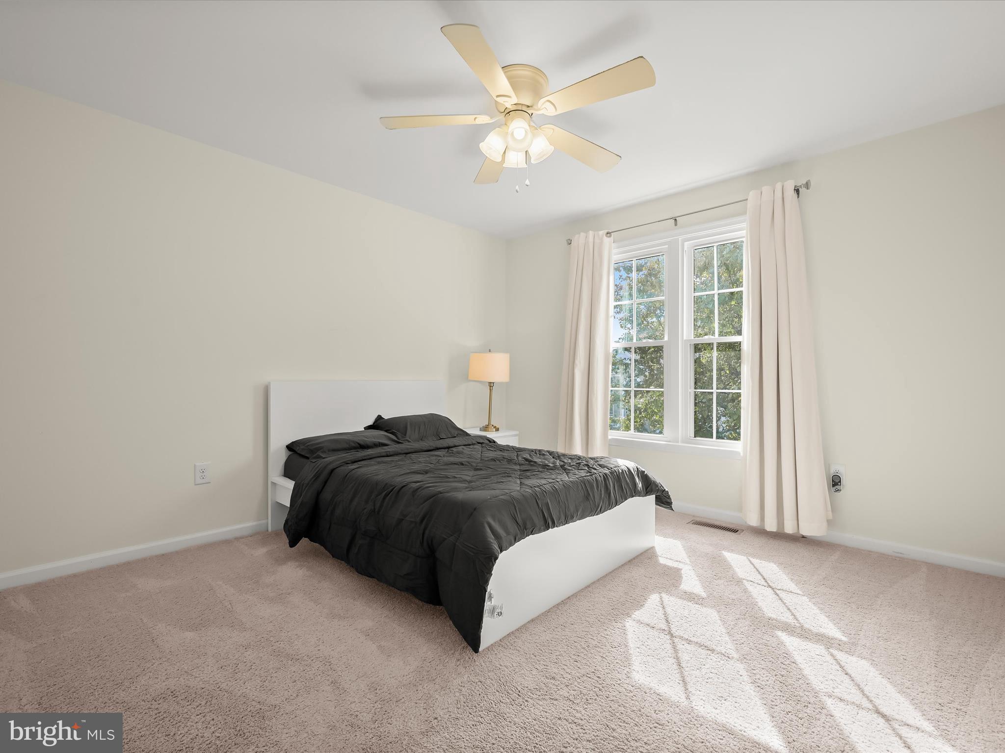 8806 Admiral Drive Laurel, MD 20708 - Photo 29 of 59 a spacious bedroom with a bed and a window