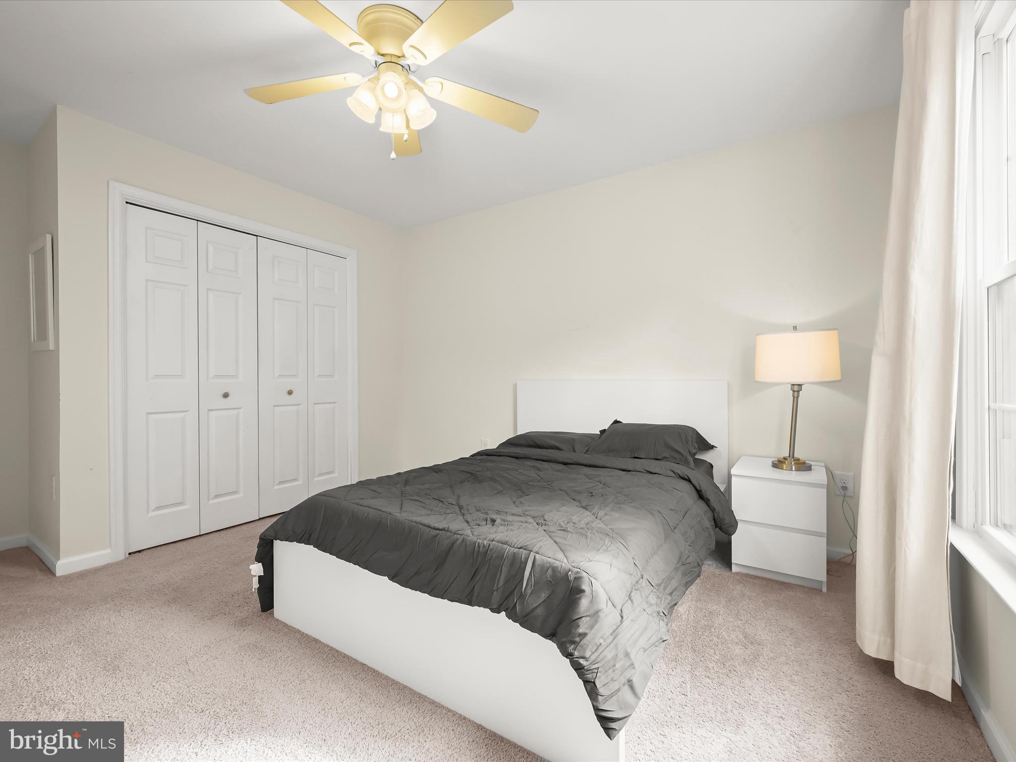 8806 Admiral Drive Laurel, MD 20708 - Photo 30 of 59 a bedroom with a bed and a chandelier