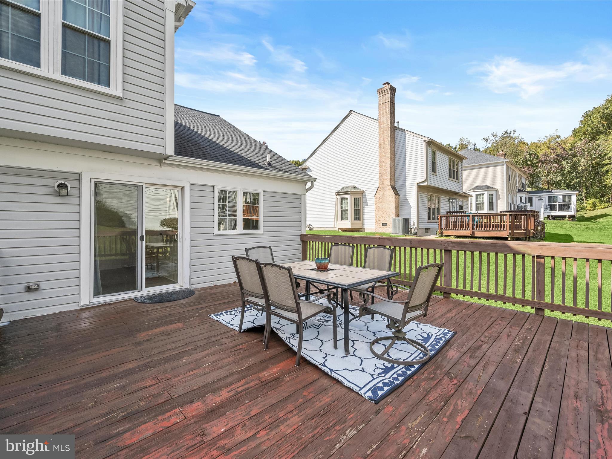 8806 Admiral Drive Laurel, MD 20708 - Photo 47 of 59 a view of a deck with table and chairs and wooden floor