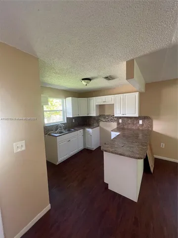 a kitchen with stainless steel appliances granite countertop a sink and a stove