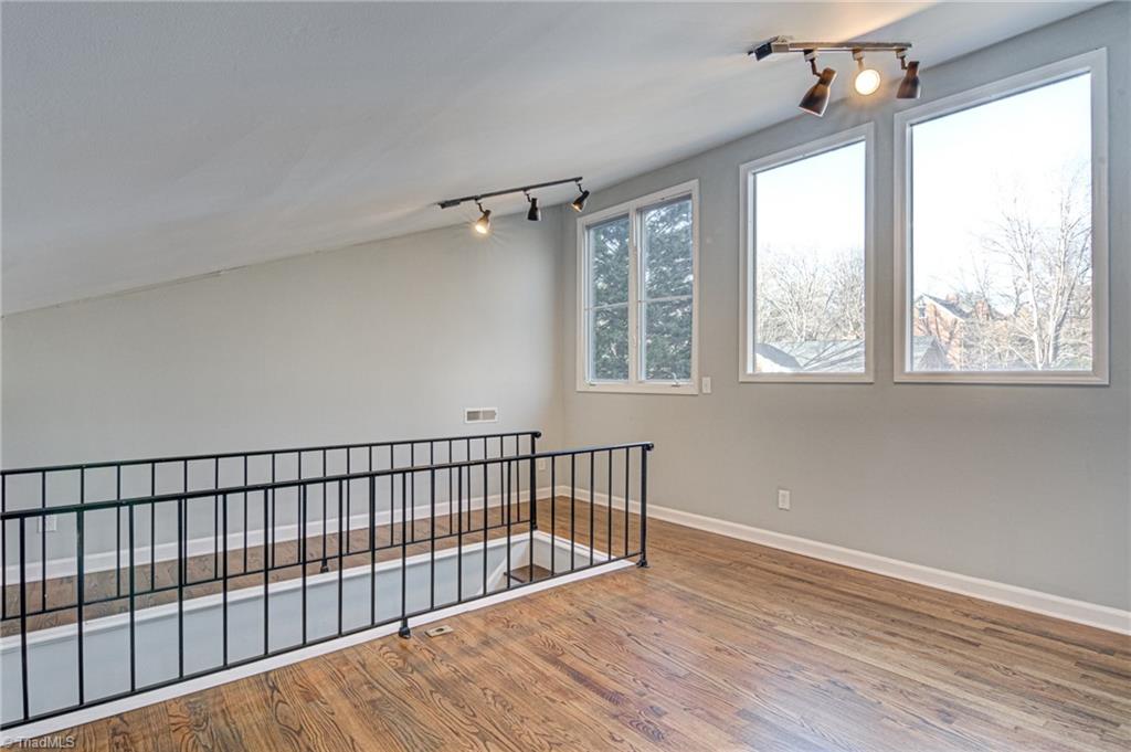 5101 Tower Road Greensboro, NC 27410 - Photo 22 of 36 Loft at bottom of stairs there is a door these windows face front of home