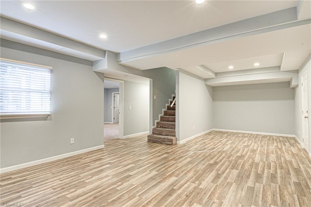 5101 Tower Road Greensboro, NC 27410 - Photo 29 of 36 Den in basement.behind the wall to the right is plumbed for kitchen
