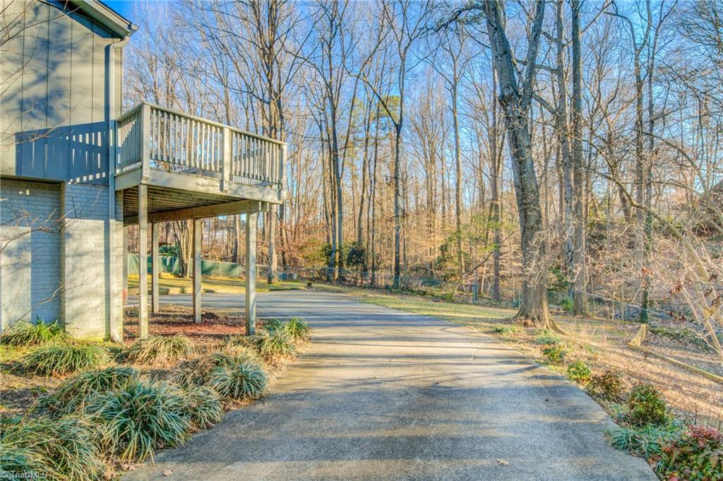 5101 Tower Road Greensboro, NC 27410 - Photo 34 of 36 Expansive driveway wraps around the back of the home where the garage is located