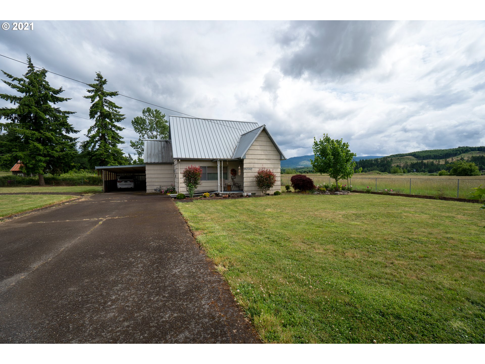 9040 Fort Hill Road Willamina, OR 97396 - Photo 11 of 27 a front view of a house with garden
