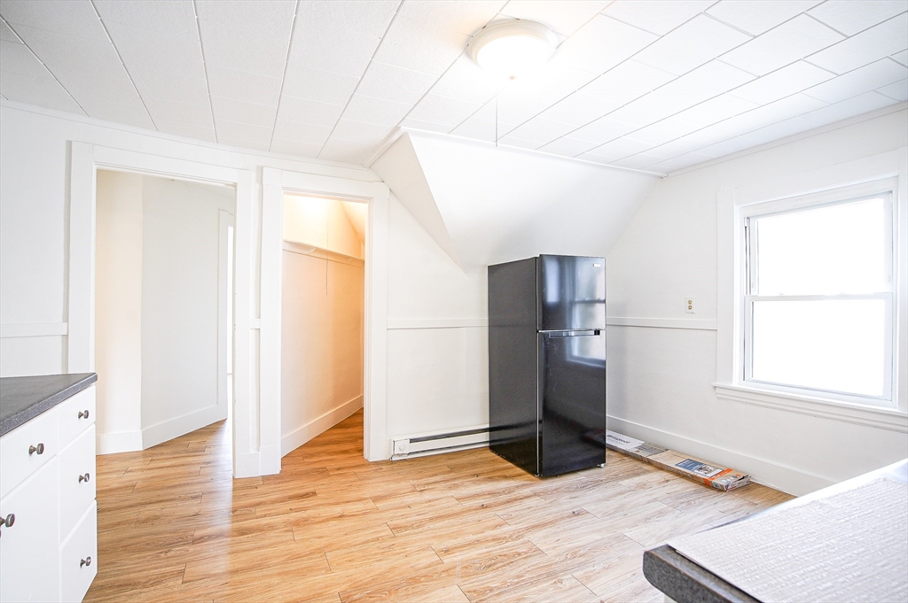 83-85 Wilmont Street, Unit 3 Springfield, MA 01108 - Photo 5 of 12 a view of empty room with wooden floor