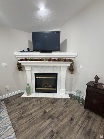 1976 River Bottom Road Springville, UT 84663 - Photo 10 of 45 White mantel fireplace with a black insert, white tile hearth, and wood-finish flooring