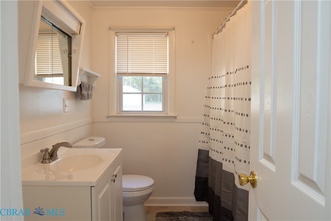 1008 Mill Creek Road Wake, VA 23176 - Photo 19 of 22 Bathroom featuring a shower with shower curtain, vanity, tile patterned floors, and crown molding