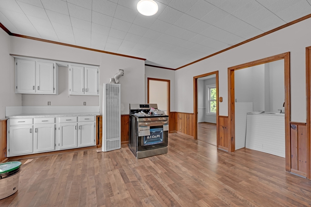 47 Morris Street Southbridge, MA 01550 - Photo 13 of 40 a kitchen with a refrigerator and a stove top oven