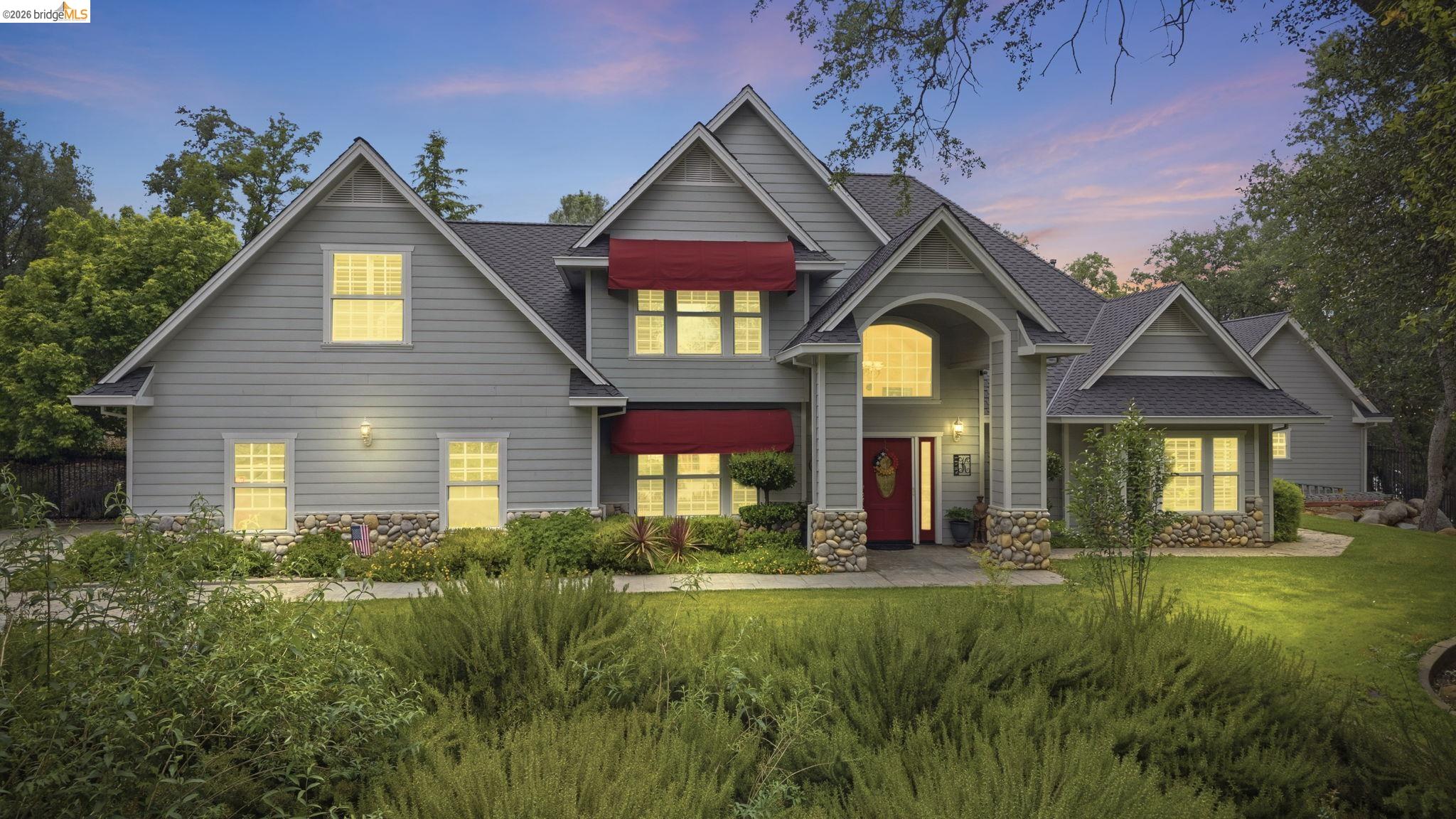18450 Lambert Lake Road Sonora, CA 95370 - Photo 1 of 87 Craftsman-style residence featuring light grey siding with stone accents