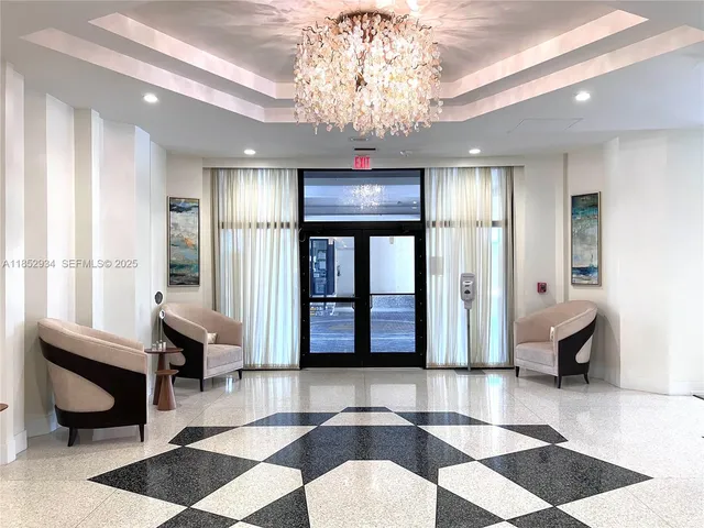 a living room with furniture and a chandelier