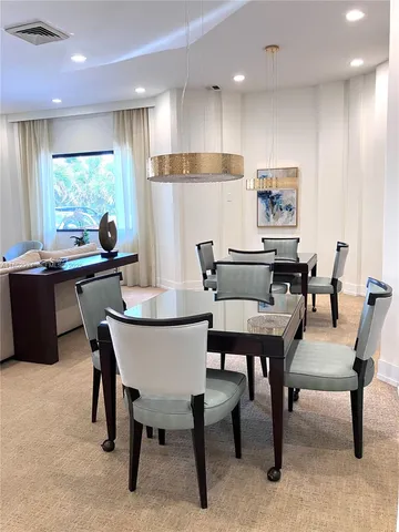 a dining table with chairs and window