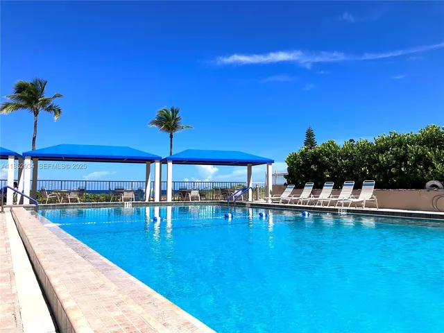 a view of a swimming pool with a table and chairs