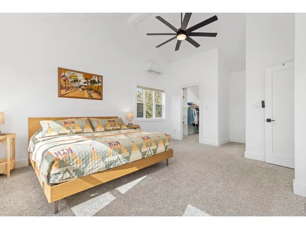 a bedroom with a bed and a ceiling fan