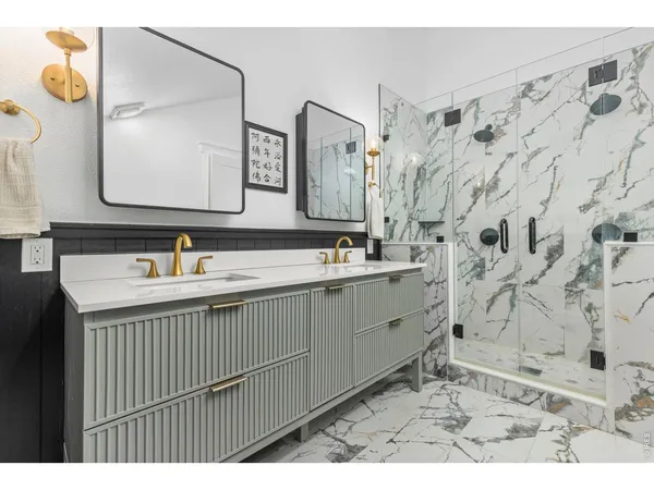 a bathroom with a double vanity sink mirror and shower