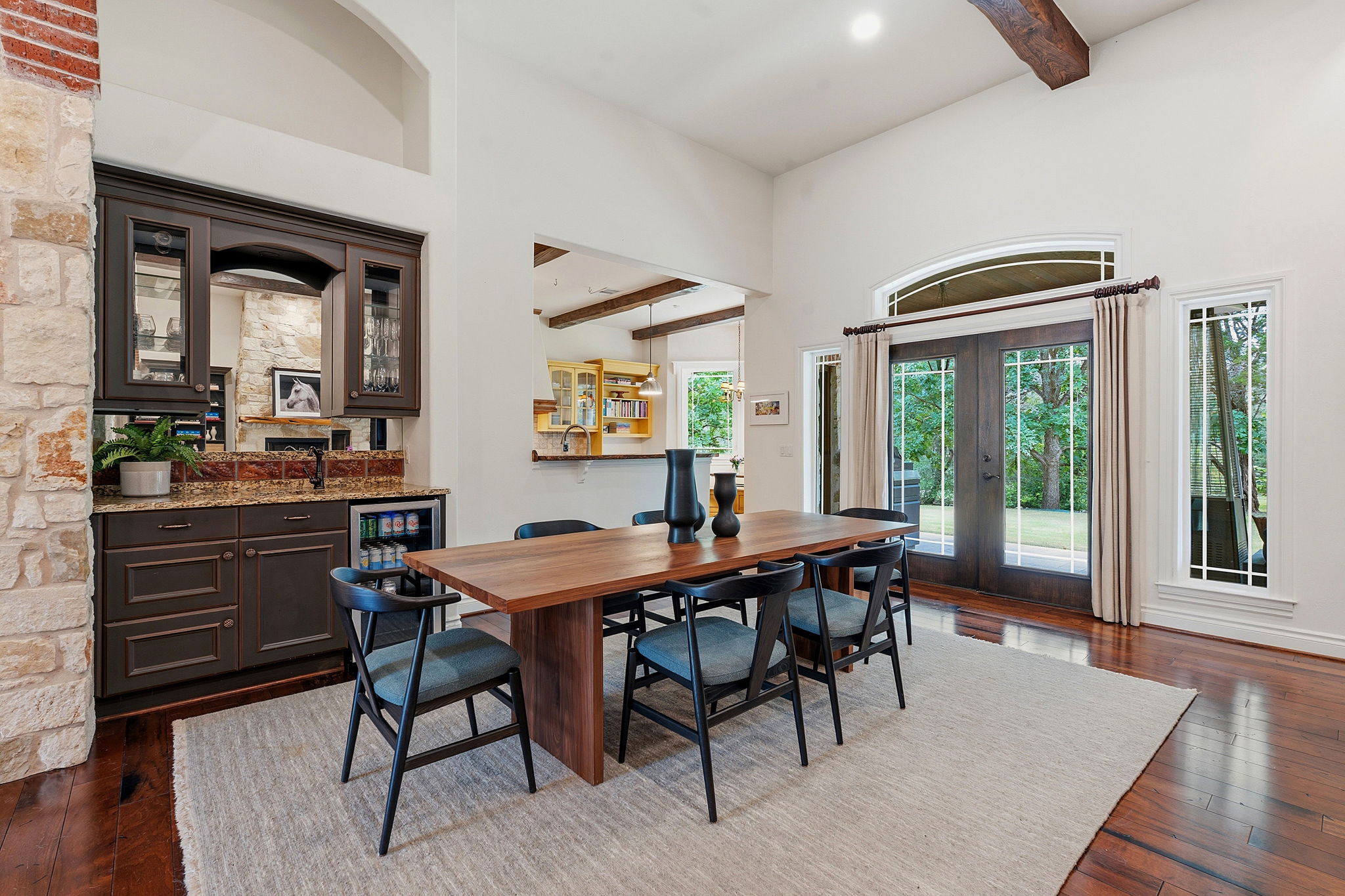 8121 Bluff Trail Austin, TX 78737 - Photo 11 of 40 A spacious dining area with wood flooring and an elegant wet bar, ideal for entertaining.