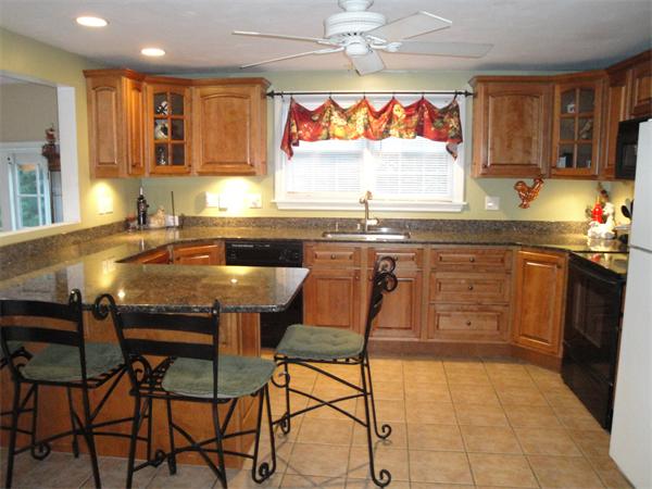 82 Campground Road Sterling, MA 01564 - Photo 4 of 23 a kitchen with stainless steel appliances granite countertop table chairs sink and window