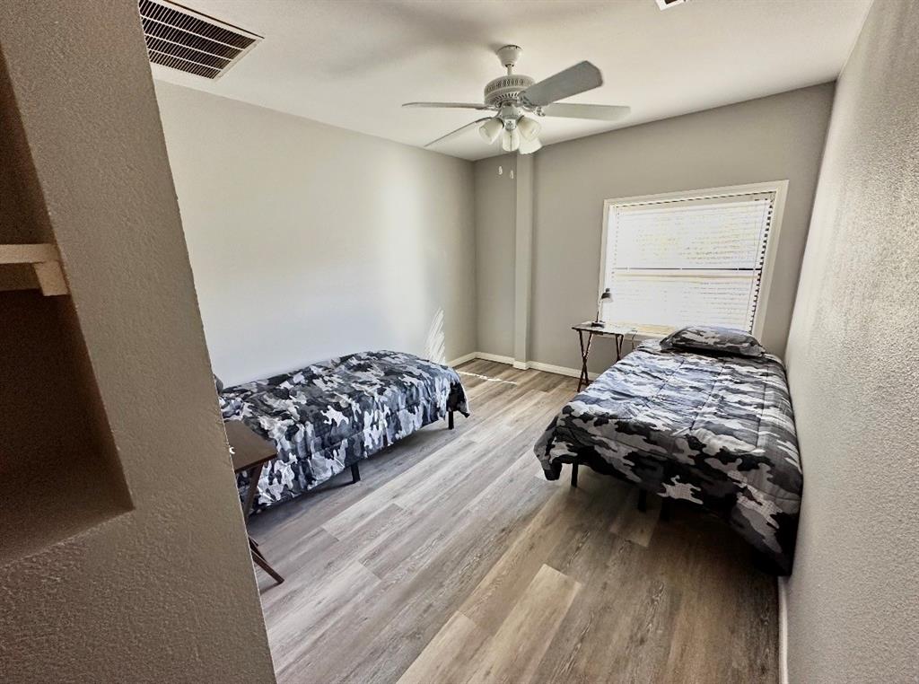 5205 Hudson Bend Road Austin, TX 78734 - Photo 20 of 21 a bedroom with a bed and a chandelier