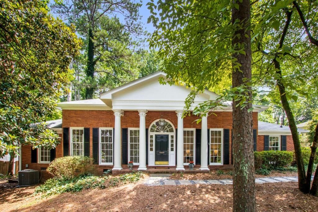 353 Old Ivy Road Northeast Atlanta, GA 30342 - Photo 1 of 1 front view of a house with a garden