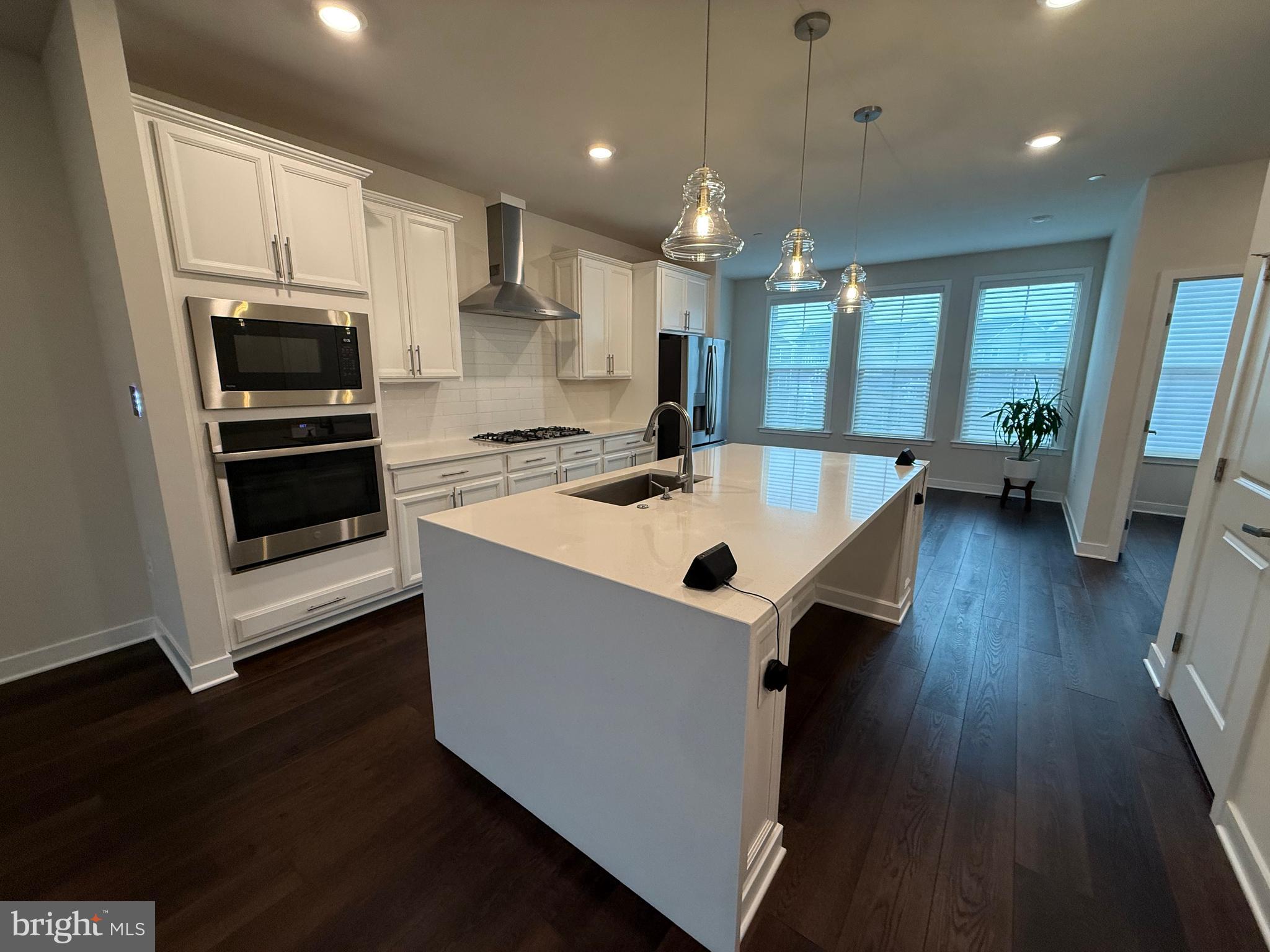 4607 Plum Road Monrovia, MD 21770 - Photo 2 of 52 a kitchen with sink a microwave and wooden floor