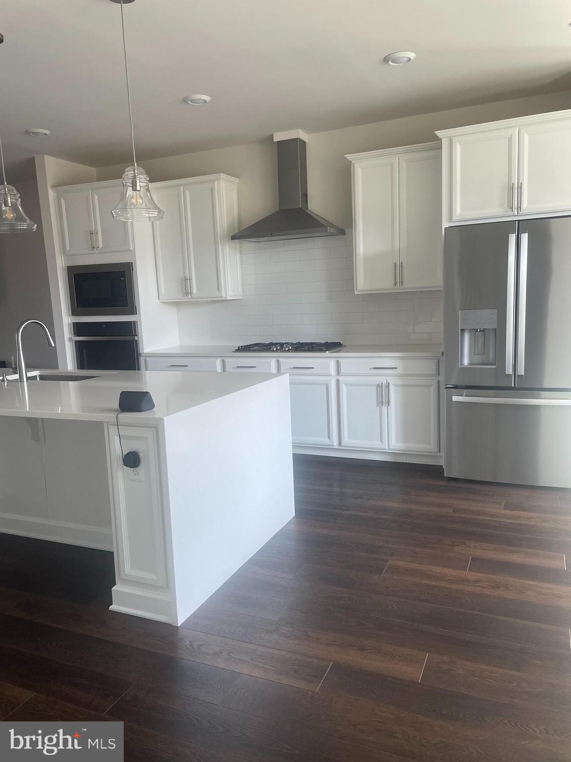 4607 Plum Road Monrovia, MD 21770 - Photo 4 of 52 a kitchen with kitchen island granite countertop a sink cabinets and stainless steel appliances