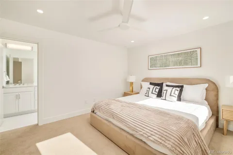 a bedroom with a bed and a painting on the wall