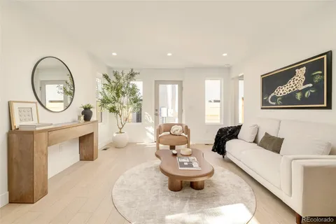 a living room with furniture a clock and a fireplace