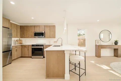a kitchen with a sink cabinets and stainless steel appliances