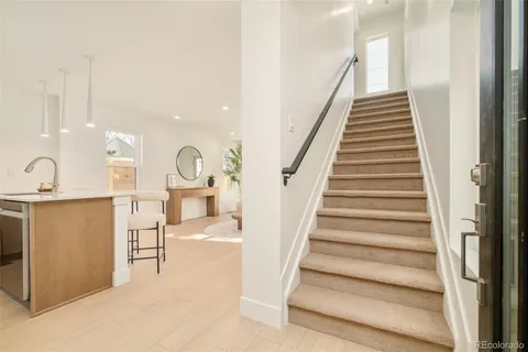 a view of entryway and hall with wooden floor
