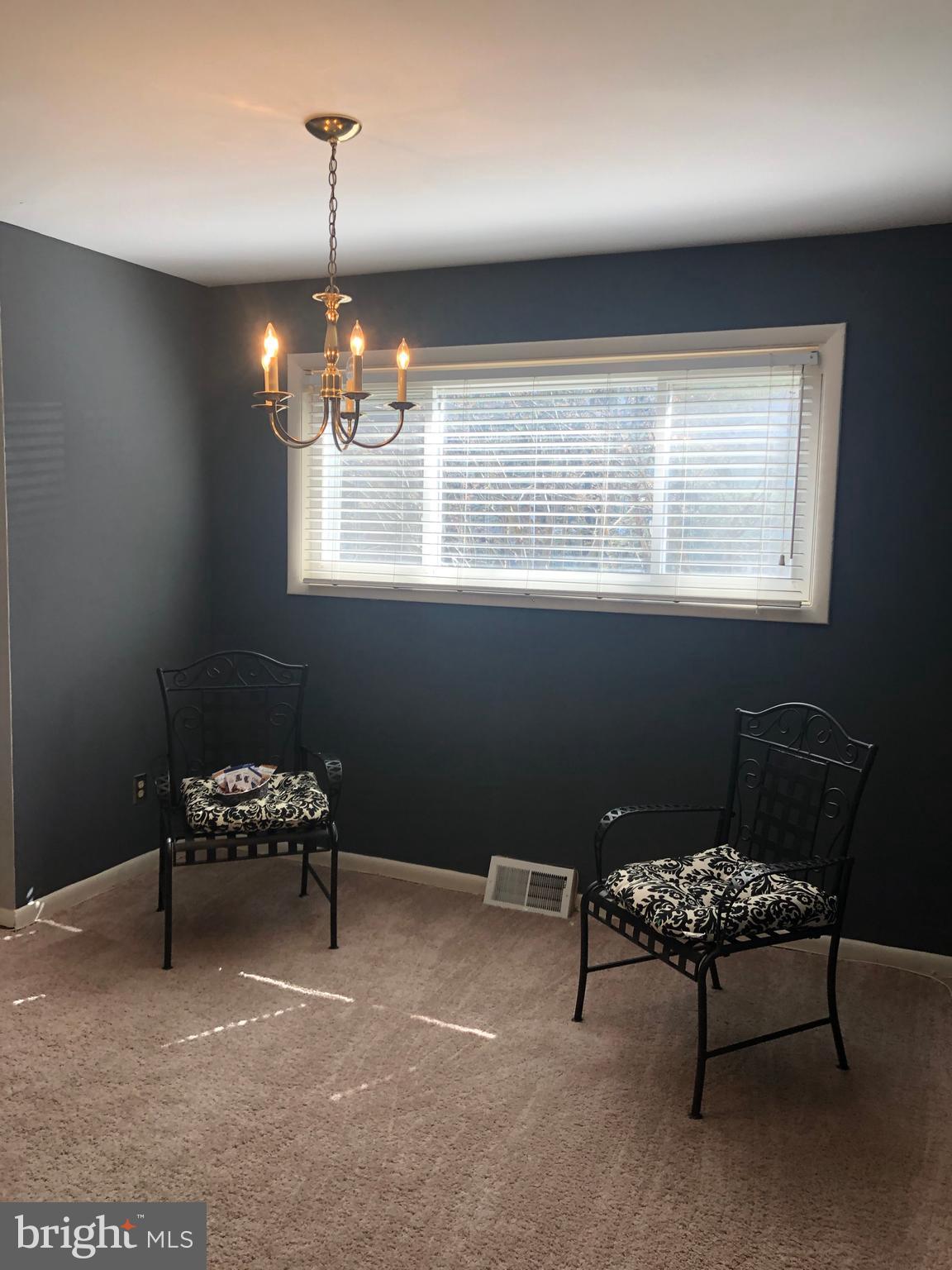 519 Epsom Road, Unit 1C Baltimore, MD 21286 - Photo 22 of 54 a bedroom with furniture and a chandelier