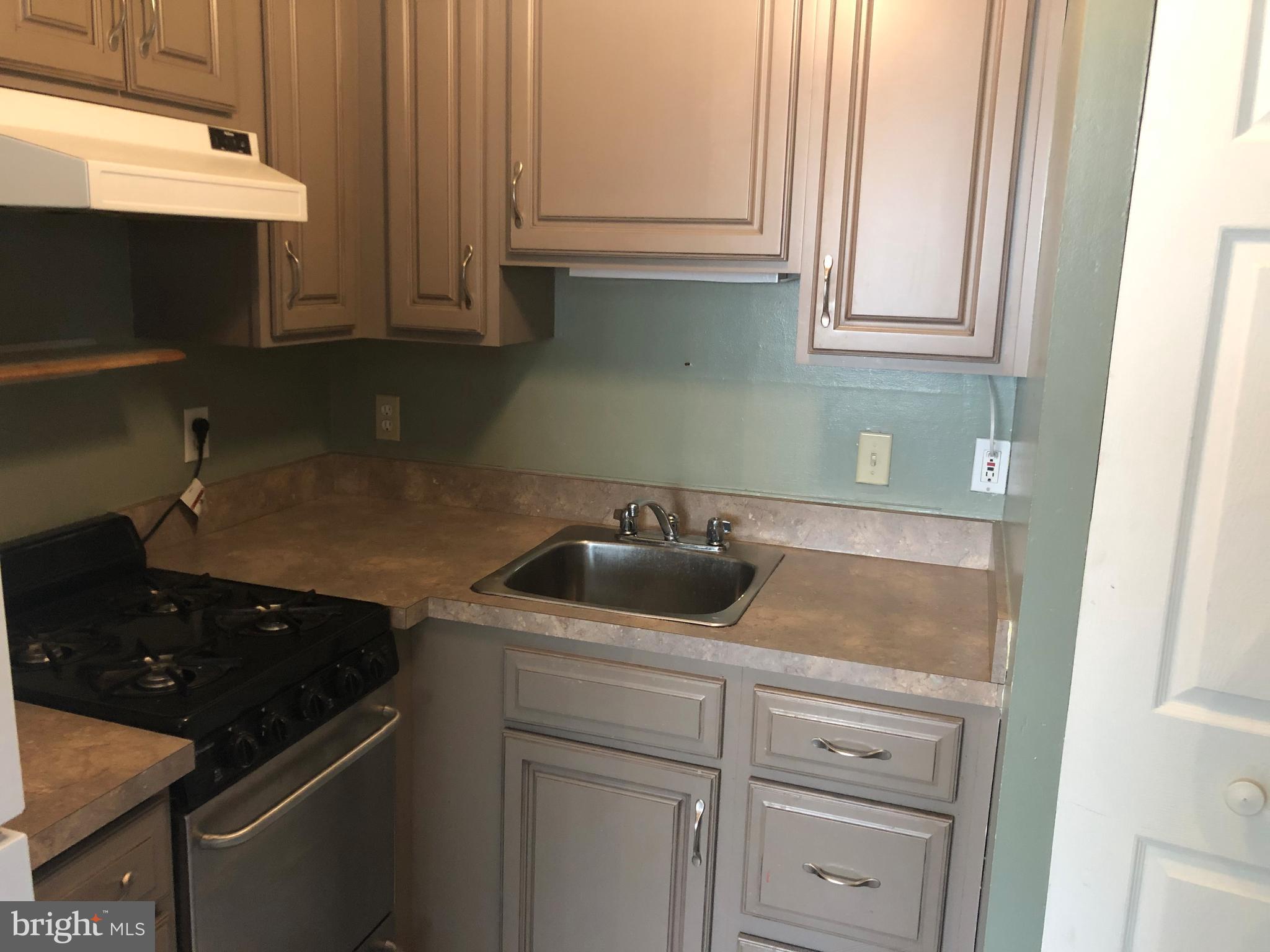 519 Epsom Road, Unit 1C Baltimore, MD 21286 - Photo 28 of 54 a kitchen with a sink and cabinets