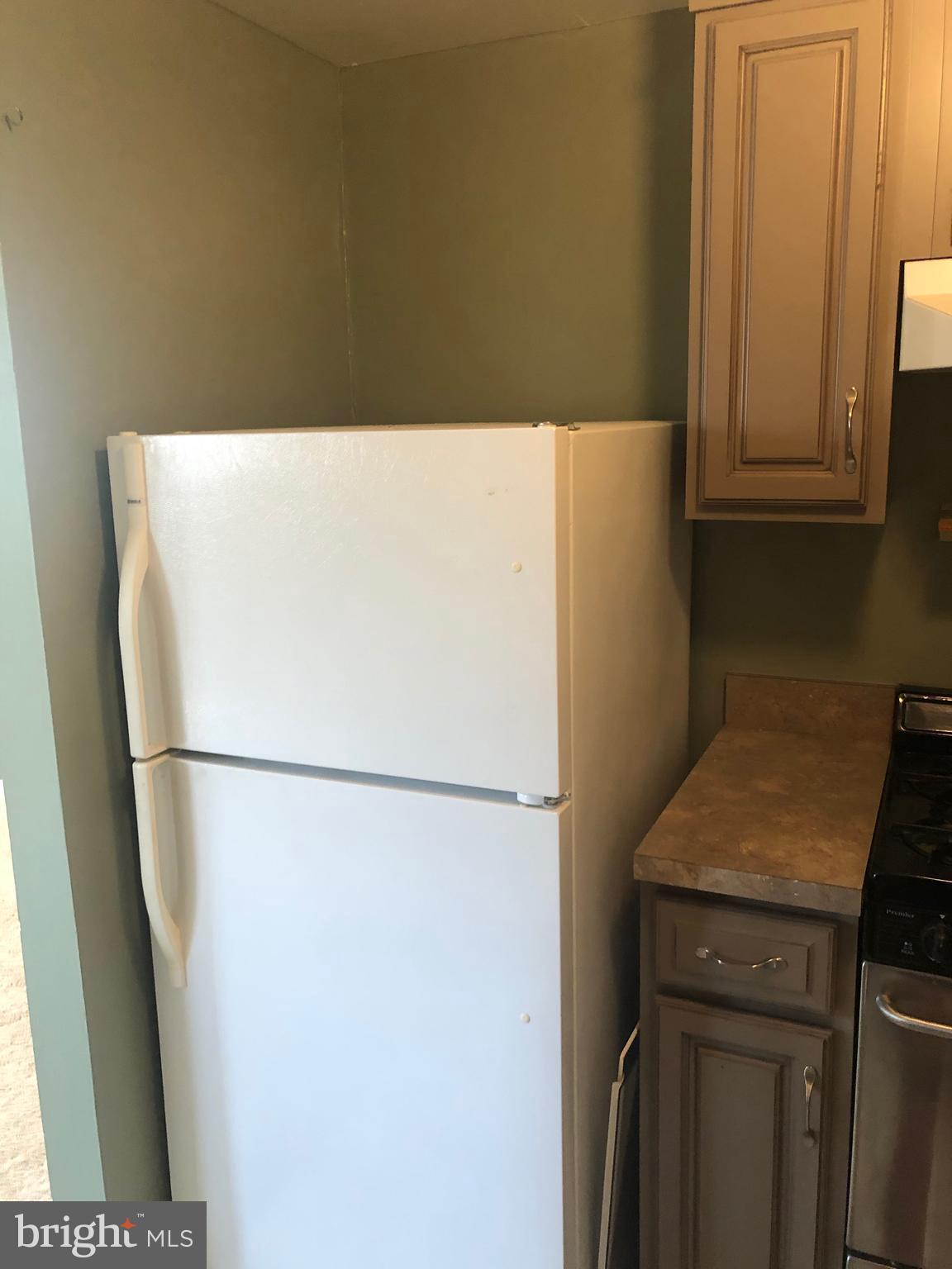519 Epsom Road, Unit 1C Baltimore, MD 21286 - Photo 30 of 54 a white refrigerator freezer sitting in a kitchen