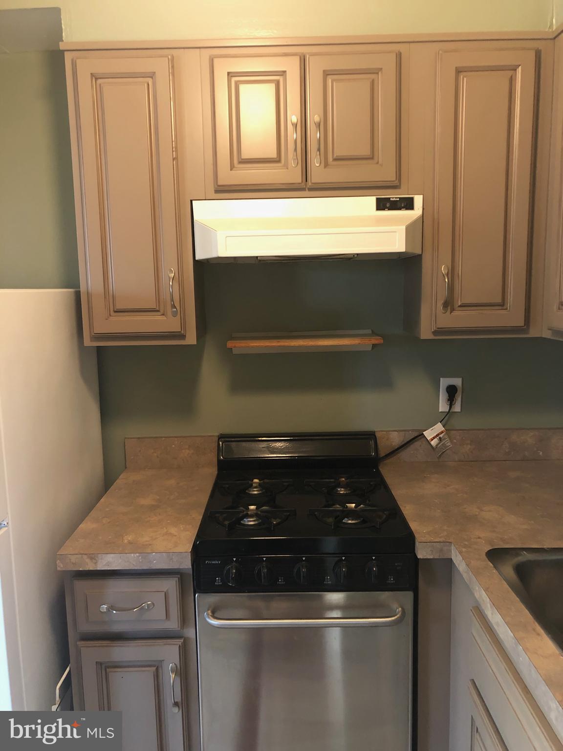 519 Epsom Road, Unit 1C Baltimore, MD 21286 - Photo 31 of 54 a stove top oven sitting inside of a kitchen