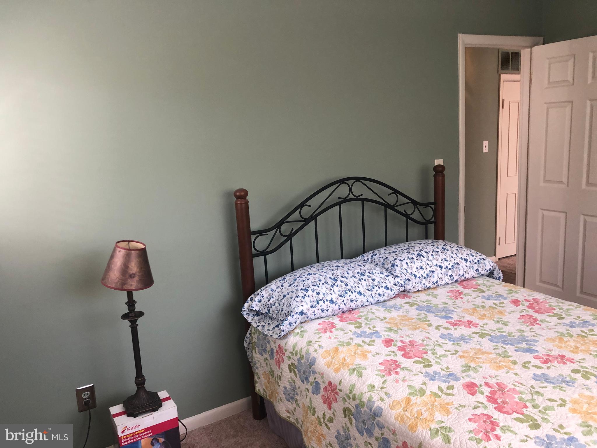 519 Epsom Road, Unit 1C Baltimore, MD 21286 - Photo 41 of 54 a bedroom with a bed and a chandelier