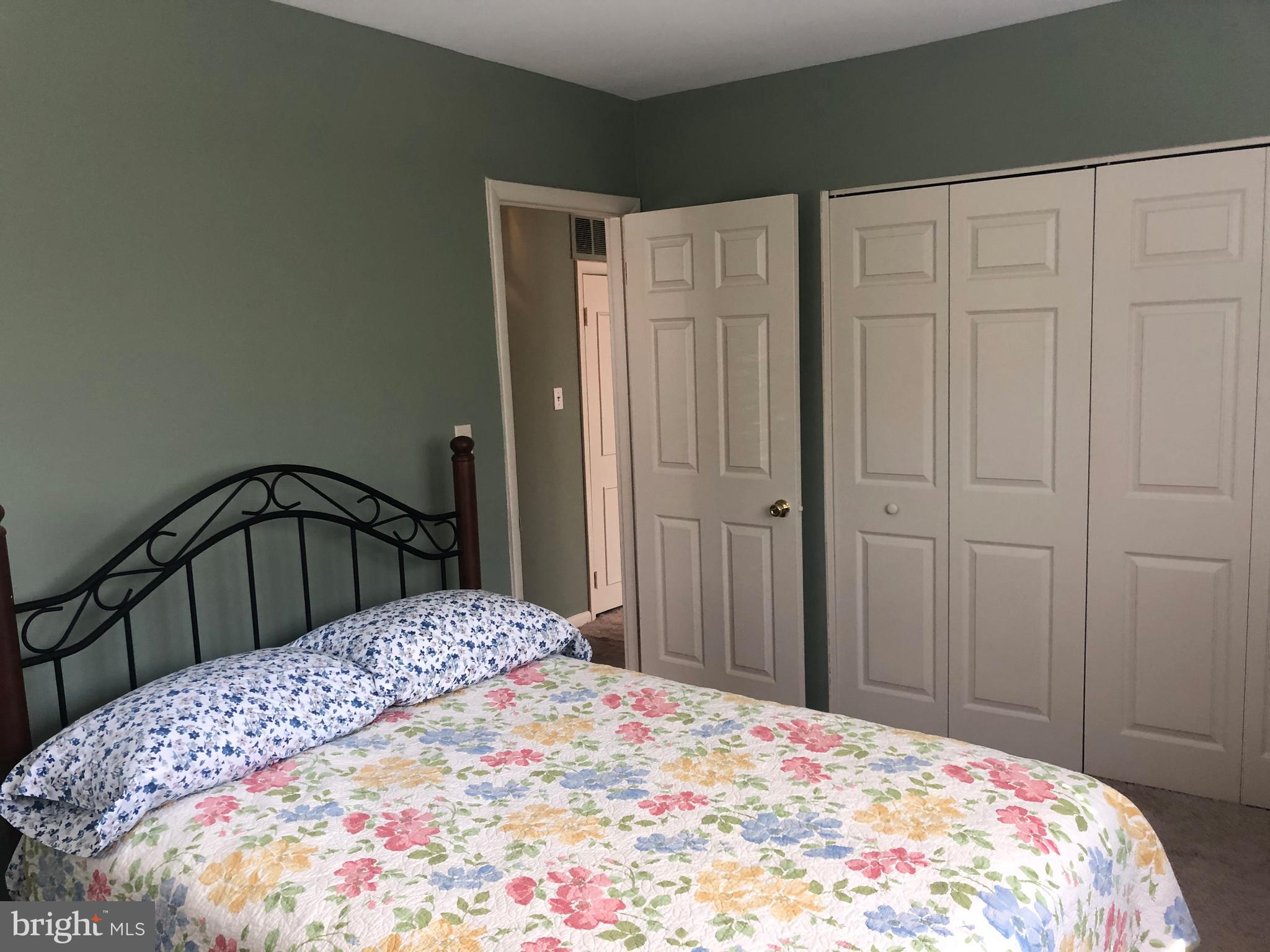519 Epsom Road, Unit 1C Baltimore, MD 21286 - Photo 42 of 54 a bedroom with a bed and a dresser
