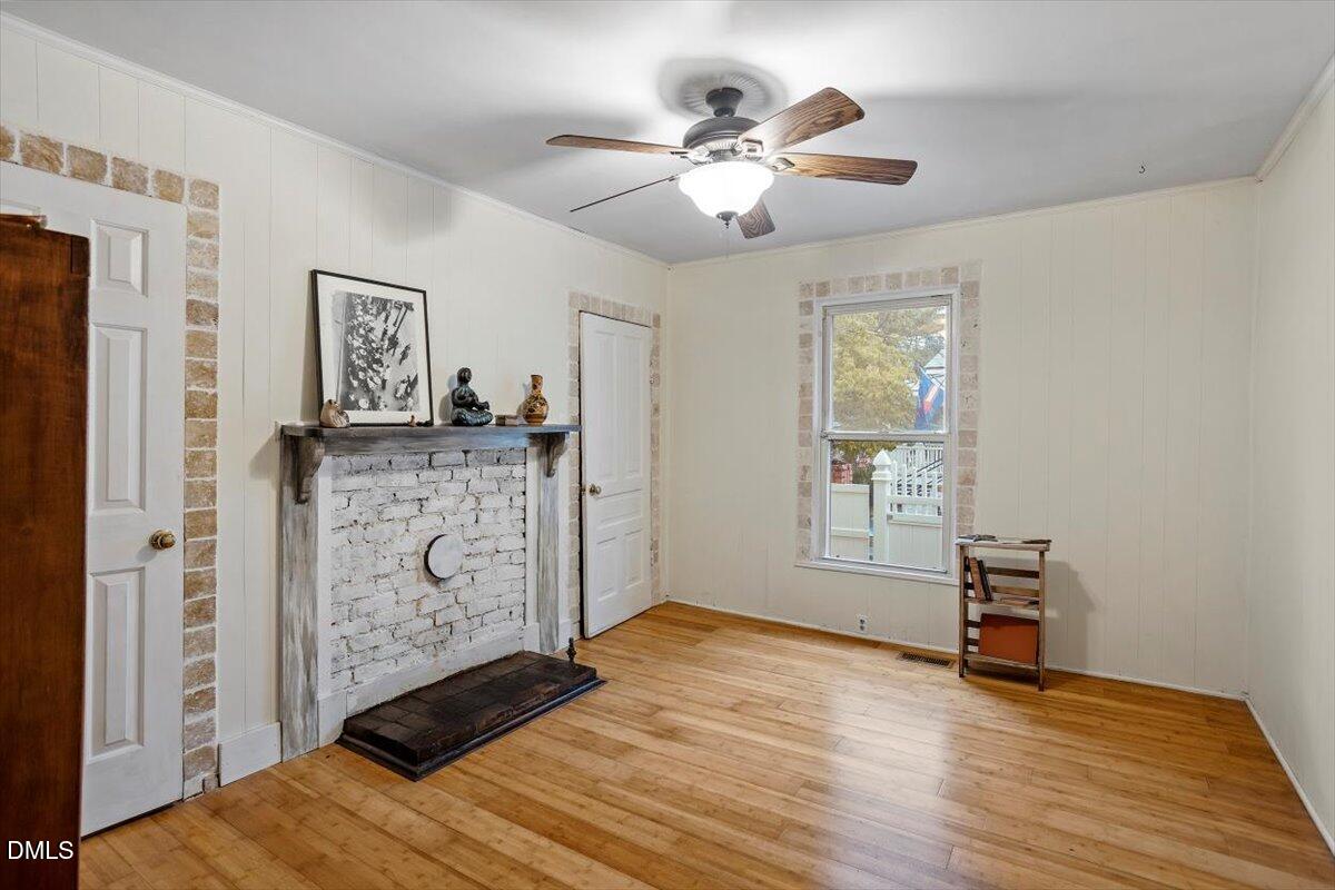 206 North State Street Raleigh, NC 27601 - Photo 11 of 21 Combining style, storage, and comfort in one inviting space, cozy meets chic in this second bedroom, complete with decorative fireplace, ceiling fan, two closets, and interior French door that enhance the space.