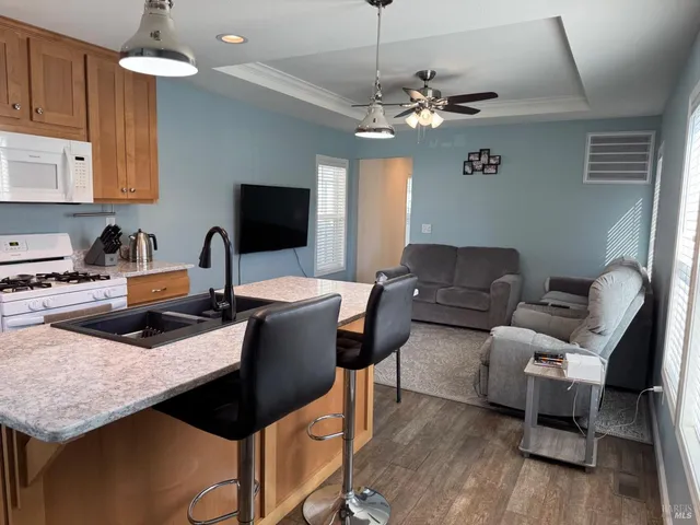 a living room with furniture a chandelier and a flat screen tv