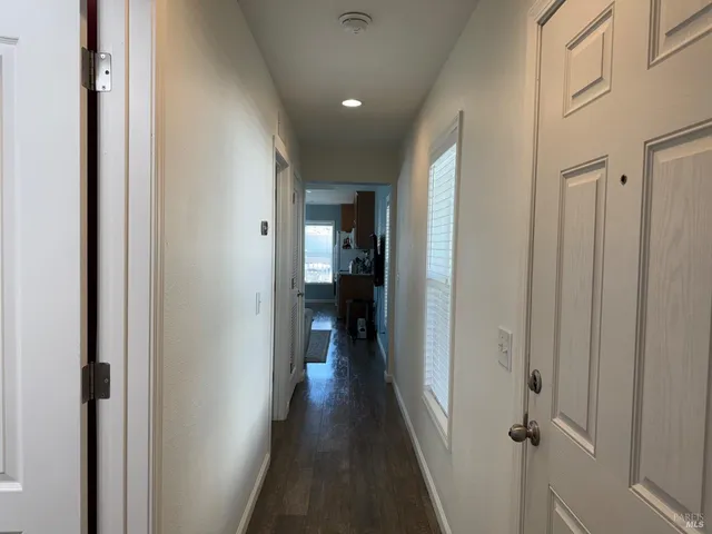 a view of a hallway with wooden floor