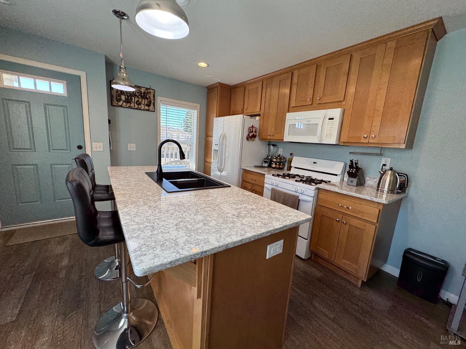 62 Romani Court Santa Rosa, CA 95407 - Photo 7 of 32 a kitchen with granite countertop a stove a sink dishwasher a dining table and chairs with wooden floor