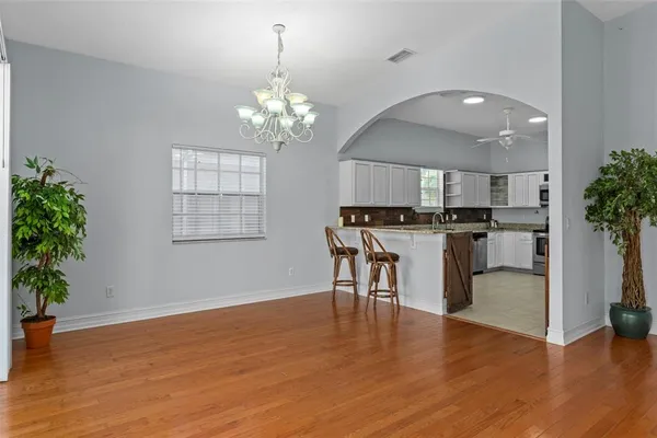 an open kitchen with kitchen island and stainless steel appliances
