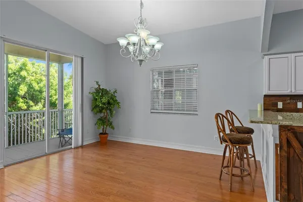 a view of a dining room with furniture wooden floor and chandelier