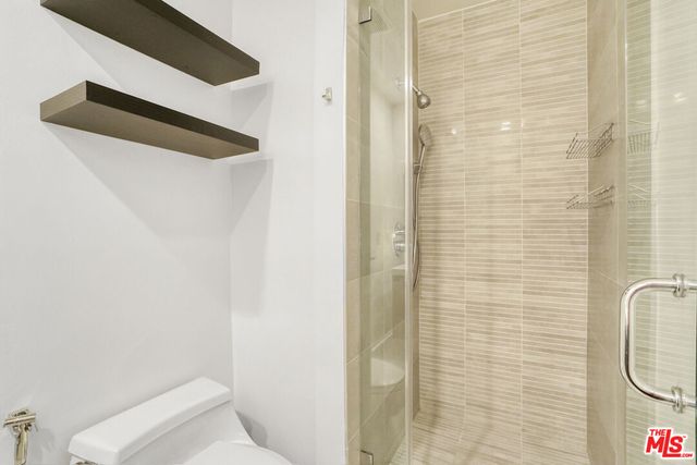 a bathroom with a toilet and shower