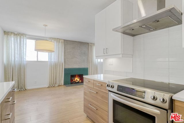 a kitchen with a stove and a refrigerator