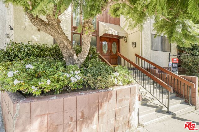 a view of a house with wooden fence