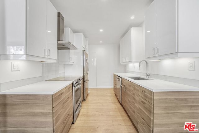 a kitchen with a sink stove and refrigerator