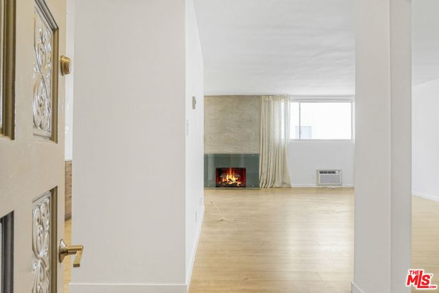 a view of an empty room with a fireplace