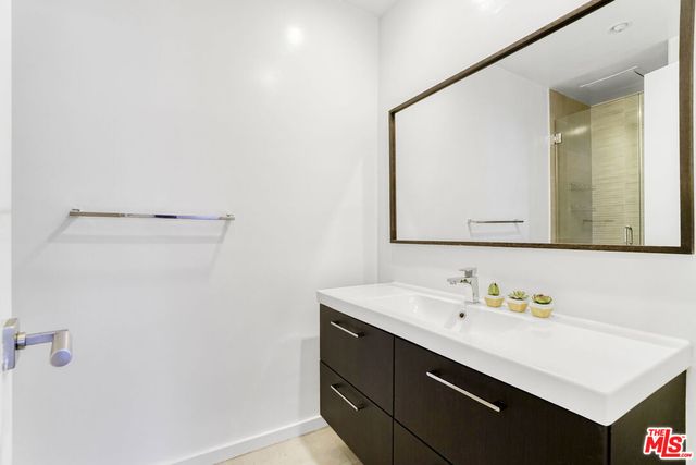 a bathroom with a sink vanity and a mirror