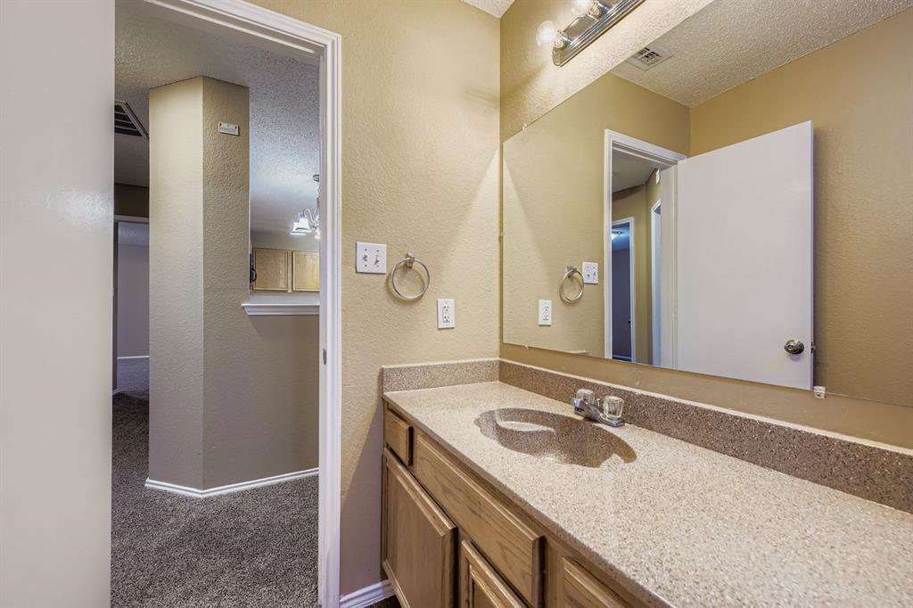 3326 Spring Meadow Lane Grand Prairie, TX 75052 - Photo 18 of 22 a bathroom with a sink and a mirror