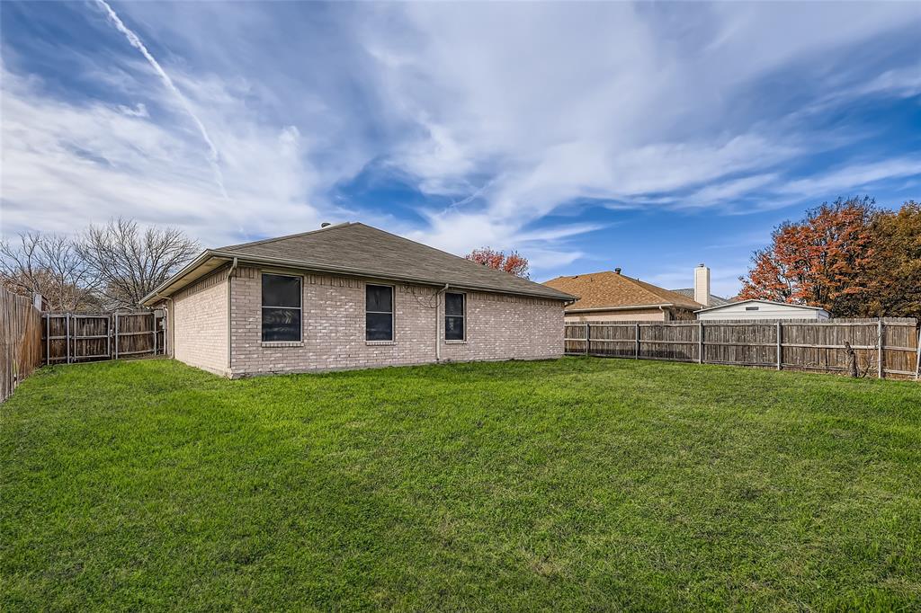 3326 Spring Meadow Lane Grand Prairie, TX 75052 - Photo 20 of 22 a view of a yard in front of a house with large trees