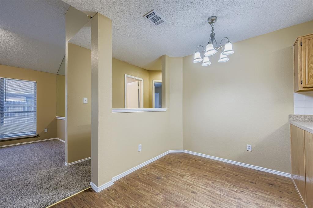 3326 Spring Meadow Lane Grand Prairie, TX 75052 - Photo 9 of 22 an empty room with chandelier fan and windows
