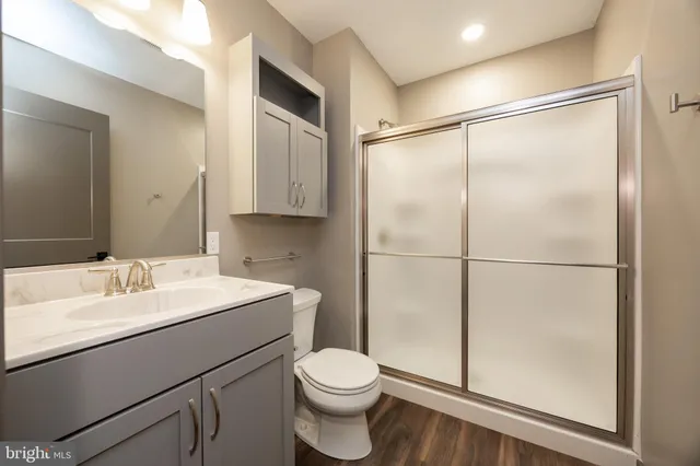 a kitchen with a refrigerator and white cabinets